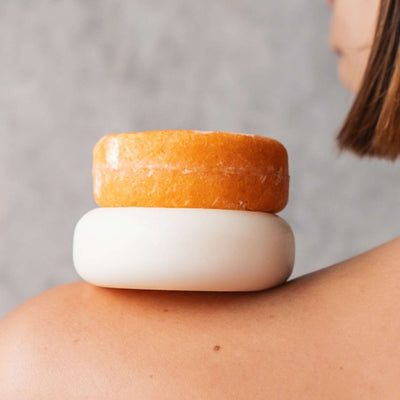 Coconut Oil Conditioner Bar on a Girls Shoulder.